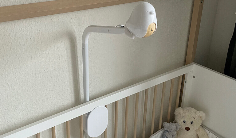 Photo of a baby nursery with the Cubo AI Plus smart baby monitor attached to the crib