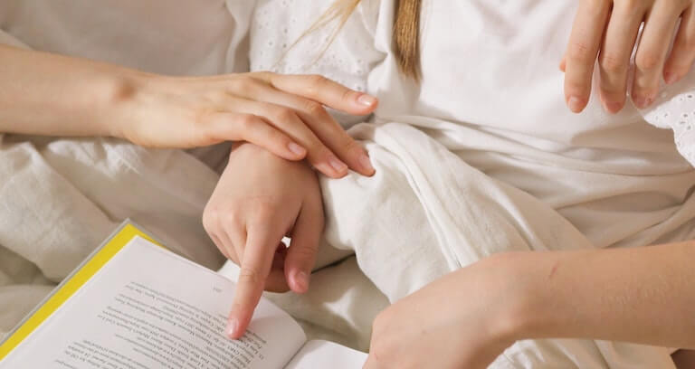 An older child reading a book by herself