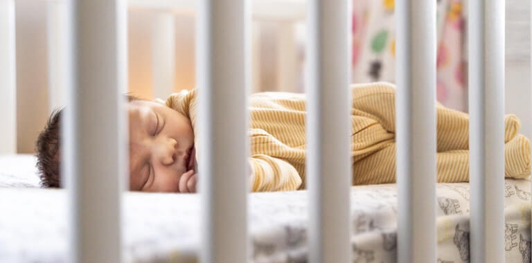 Baby sleeping in their crib