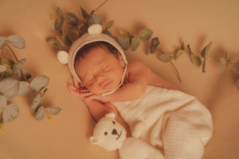 Baby girl sleeping alone with a stuffed animal