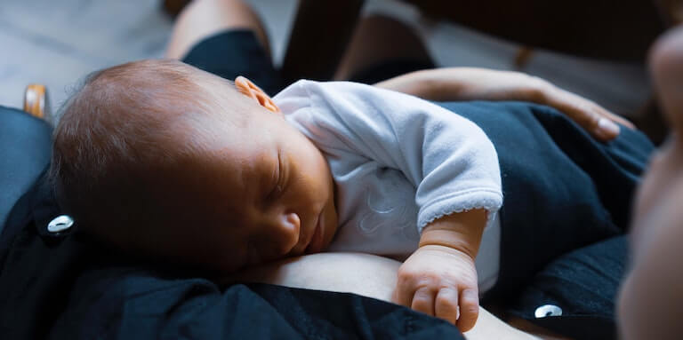 Baby sleeping on mother