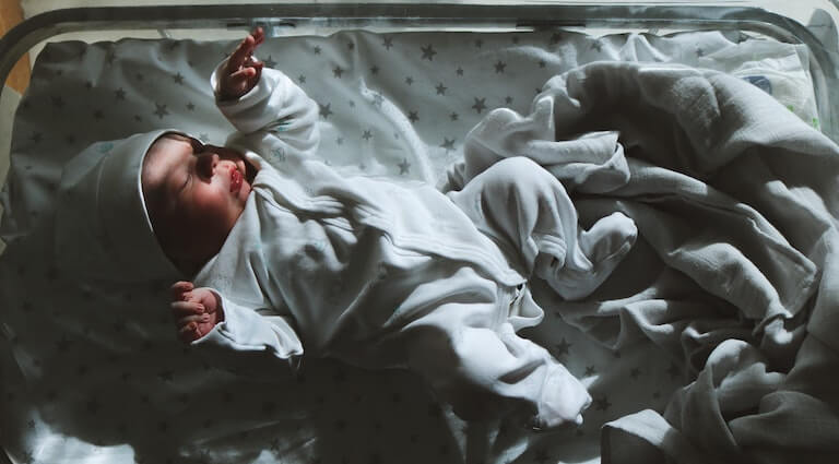 Newborn baby in warm clothes sleeping