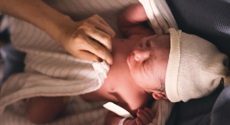 Newborn baby with a hat on