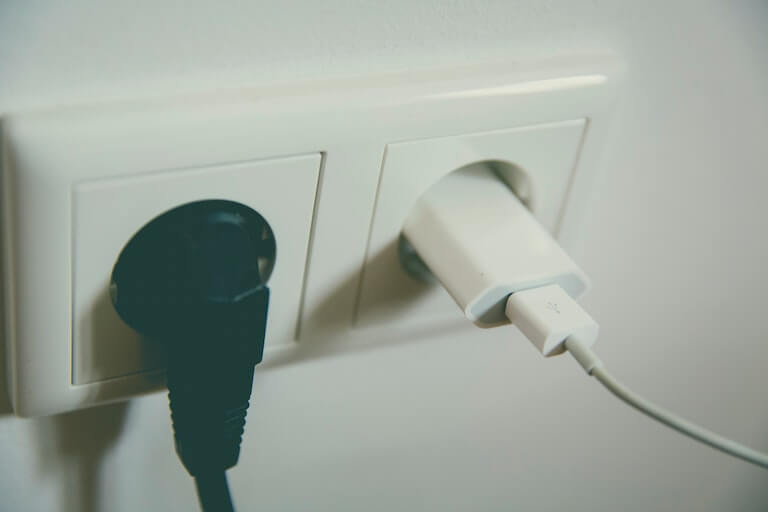 Wall socker with electronics plugged in