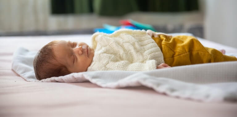 Newborn baby sleeping on their back