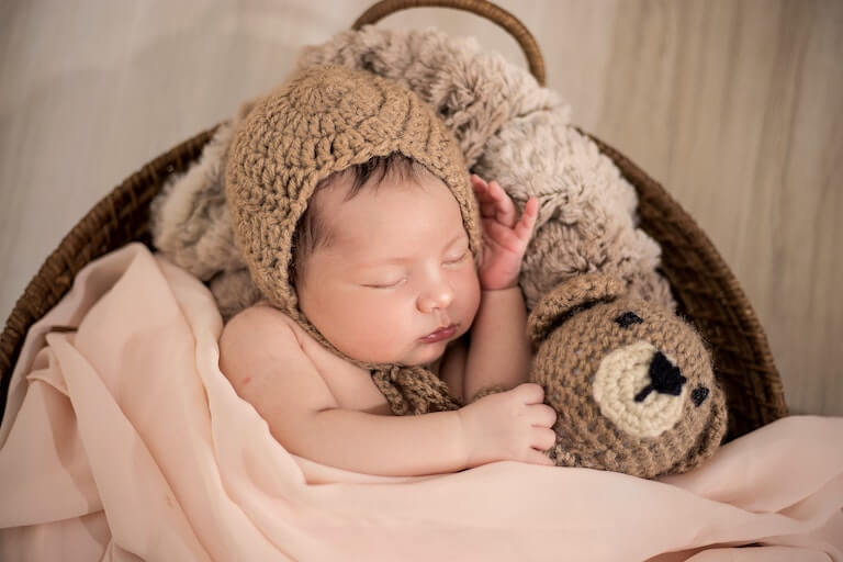 Tiny baby sleeping in a basket