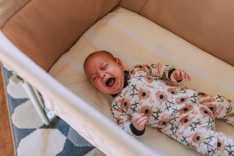 Baby in bed crying