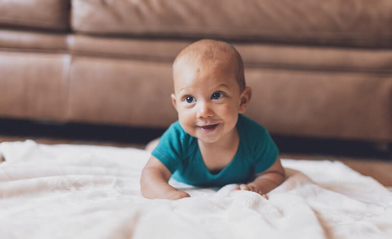 Baby crawling around on a blanket