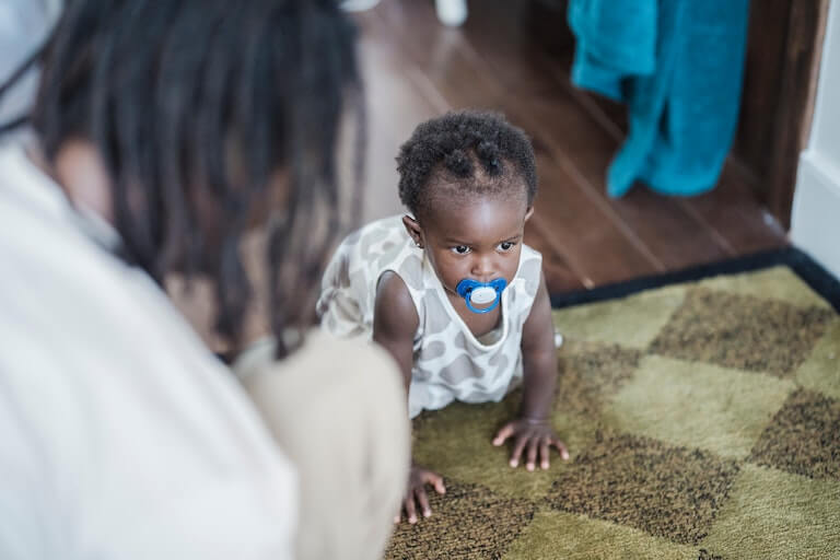 Baby crawling on a carpet