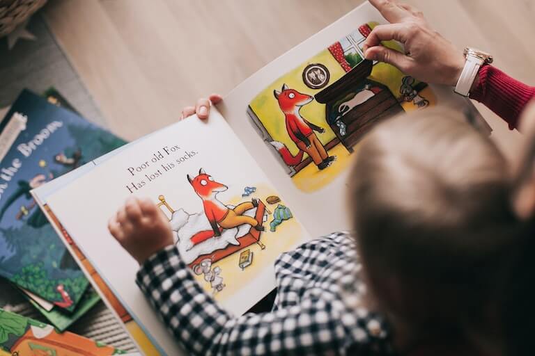 Child reading a book by themself