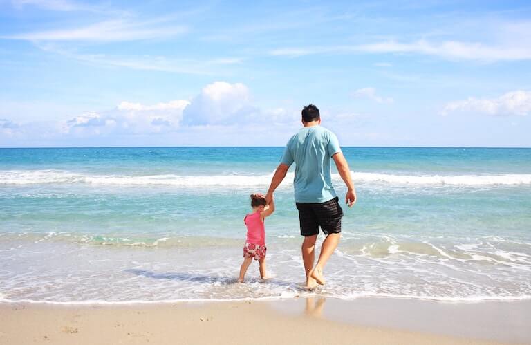Father and daughter enjoying beach vacation together