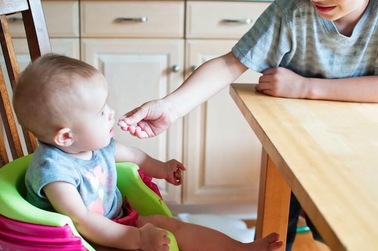 Baby in a chair being fed