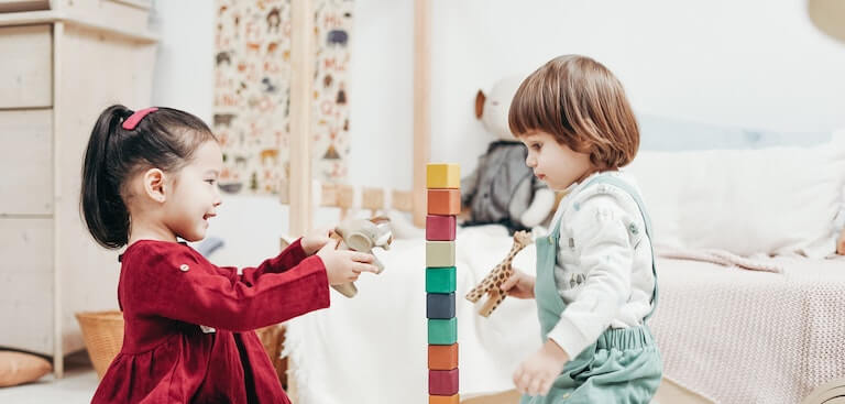 Children playing together with blocks on the floor