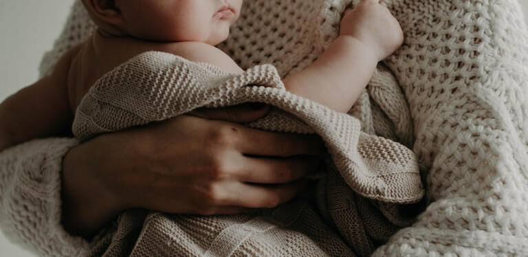 Baby being held in mothers arms