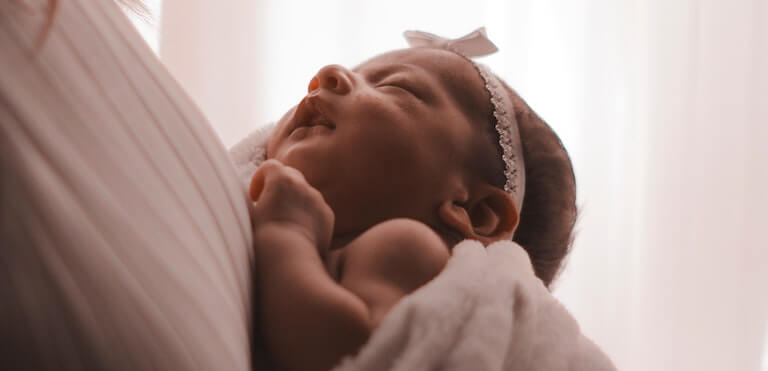 Mom holding a sleeping baby