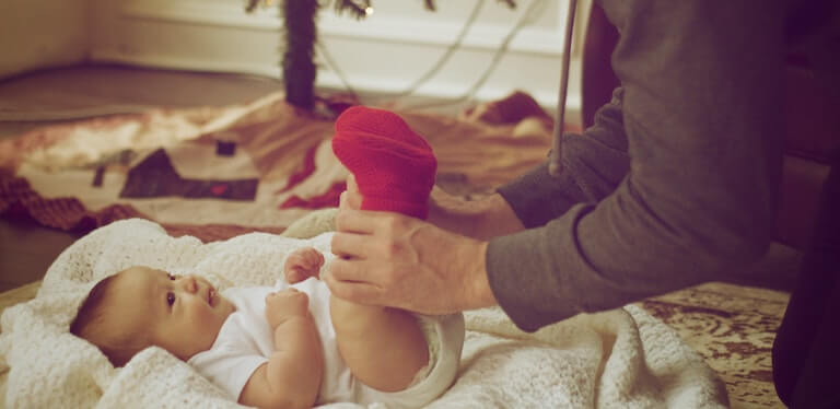 Dad holding newborns feet