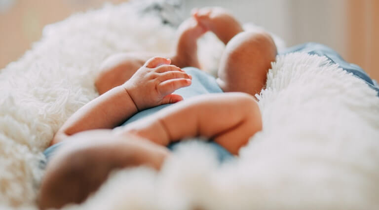 Newborn in baby bed