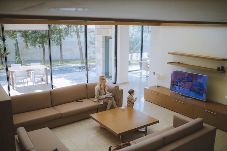 Child in the living room looking at a television