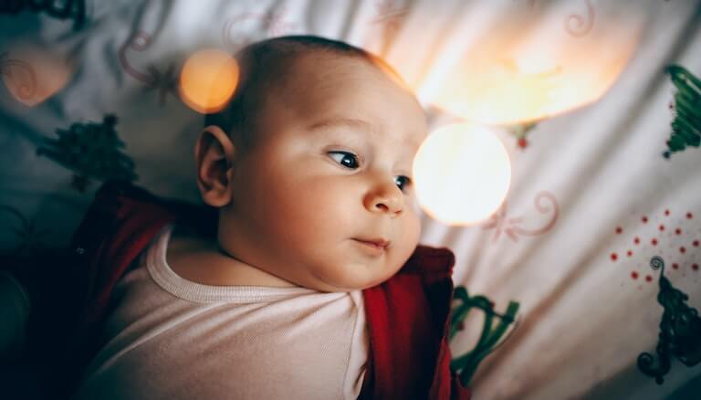 Newborn baby gazing off into the distance