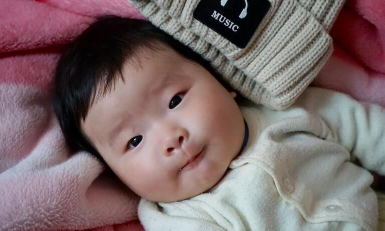 Asian newborn baby looking ahead