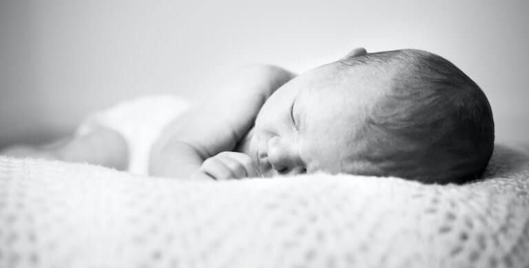 Black and white photo of a newborn baby