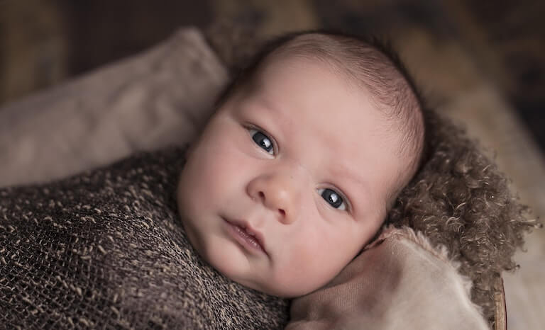 Newborn baby looking straight ahead