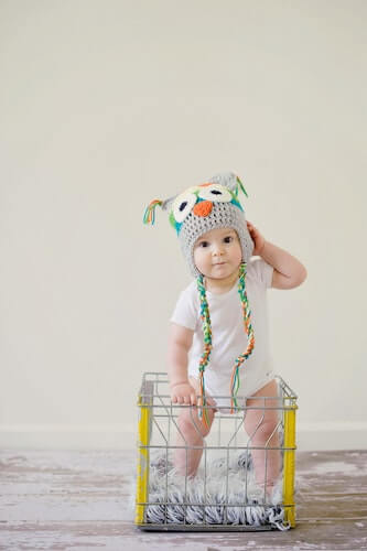 A small child standing in a basket